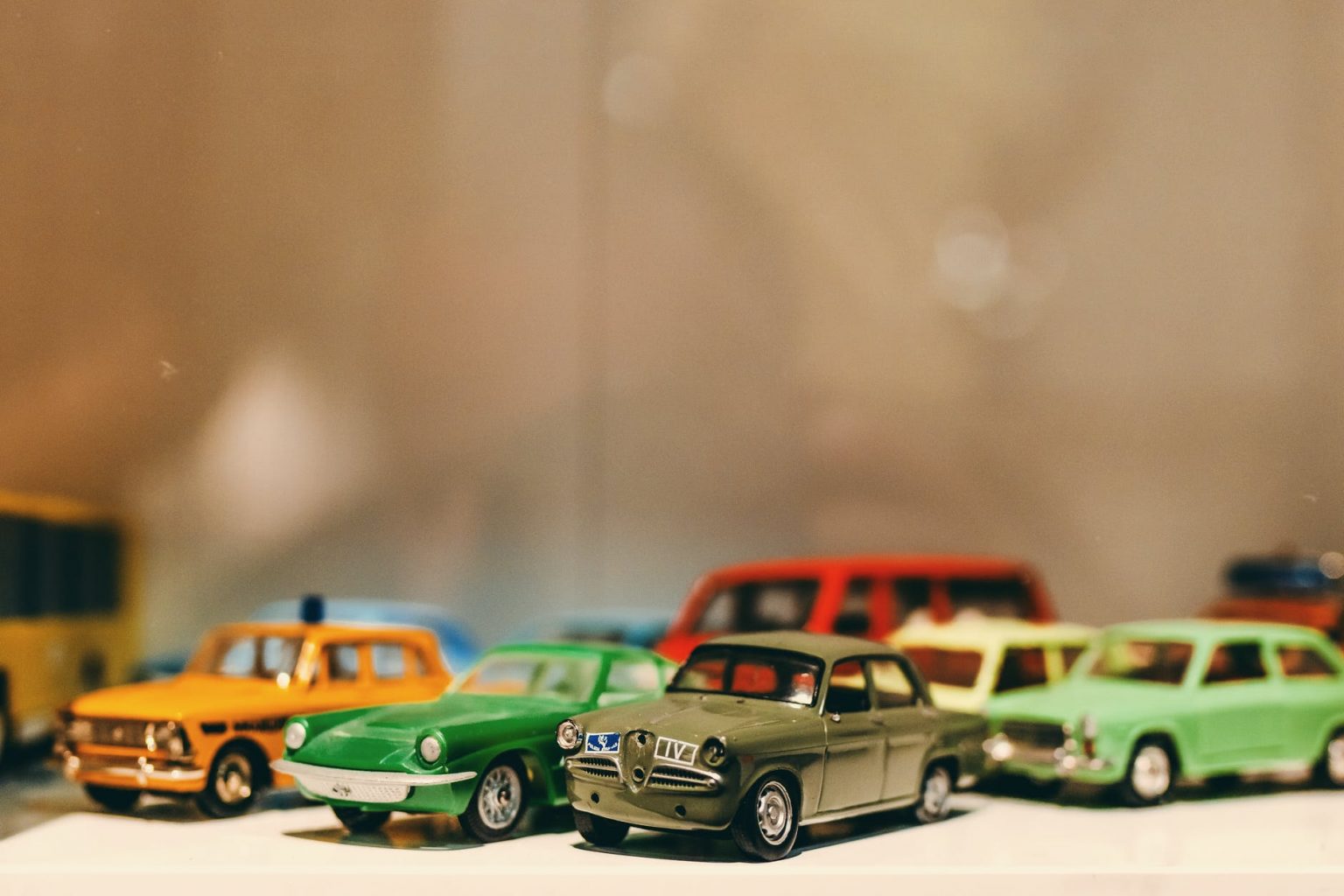 assorted color toy car miniatures on white surface
