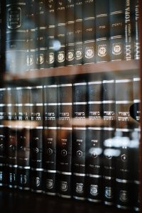 brown wooden shelf with books